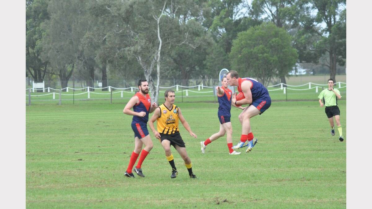 NOWRA: Albatross Demons player Grant Hoffman jumps to great heights to take a mark on Saturday against Northern Districts. 
