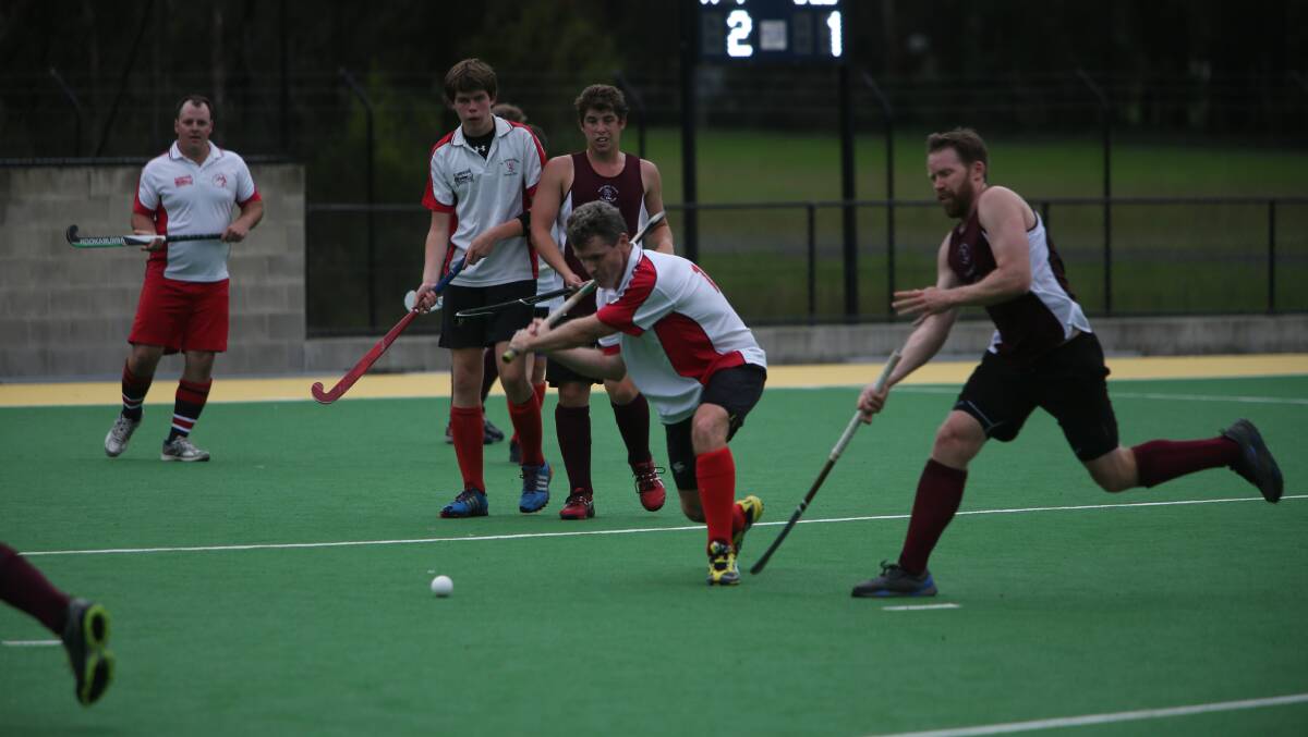 SHOALHAVEN: St Georges Basin’s Vaughan Macdonald lines up a shot while Kangaroo Valley’s Dan Knapp tries hard to stop him in the team’s match on Saturday at the Bernie Regan Sporting Complex. Photo: ROB CRAWFORD 