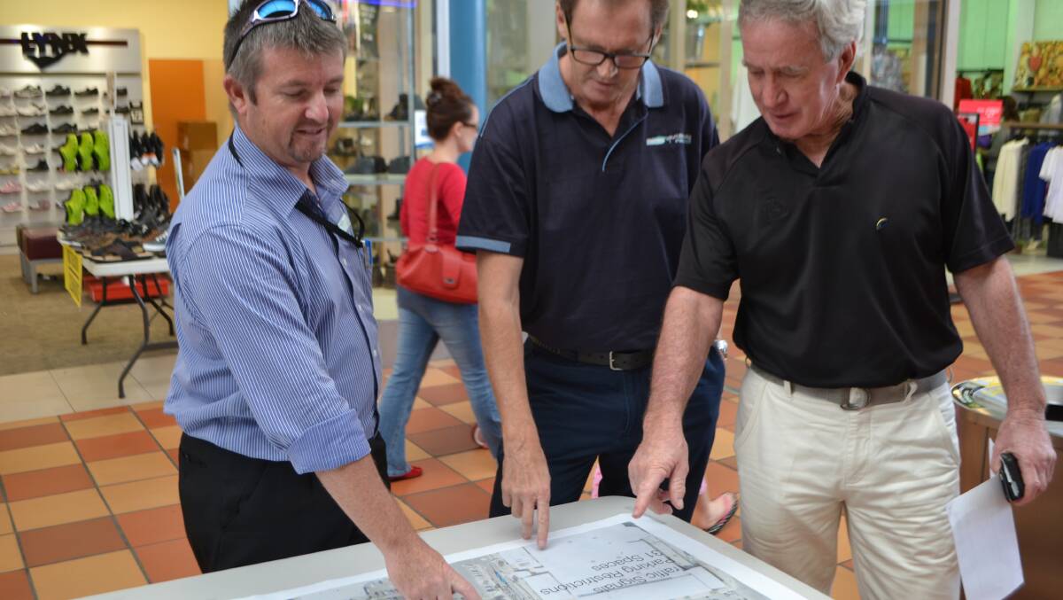 BATEMANS BAY: Eurobodalla Shire Council’s divisional manager of technical services Greg Miller, mayor Lindsay Brown and resident Kim Odgers discuss plans to install a new set of traffic lights at the North and Perry Street intersection in the Batemans Bay CBD.
 