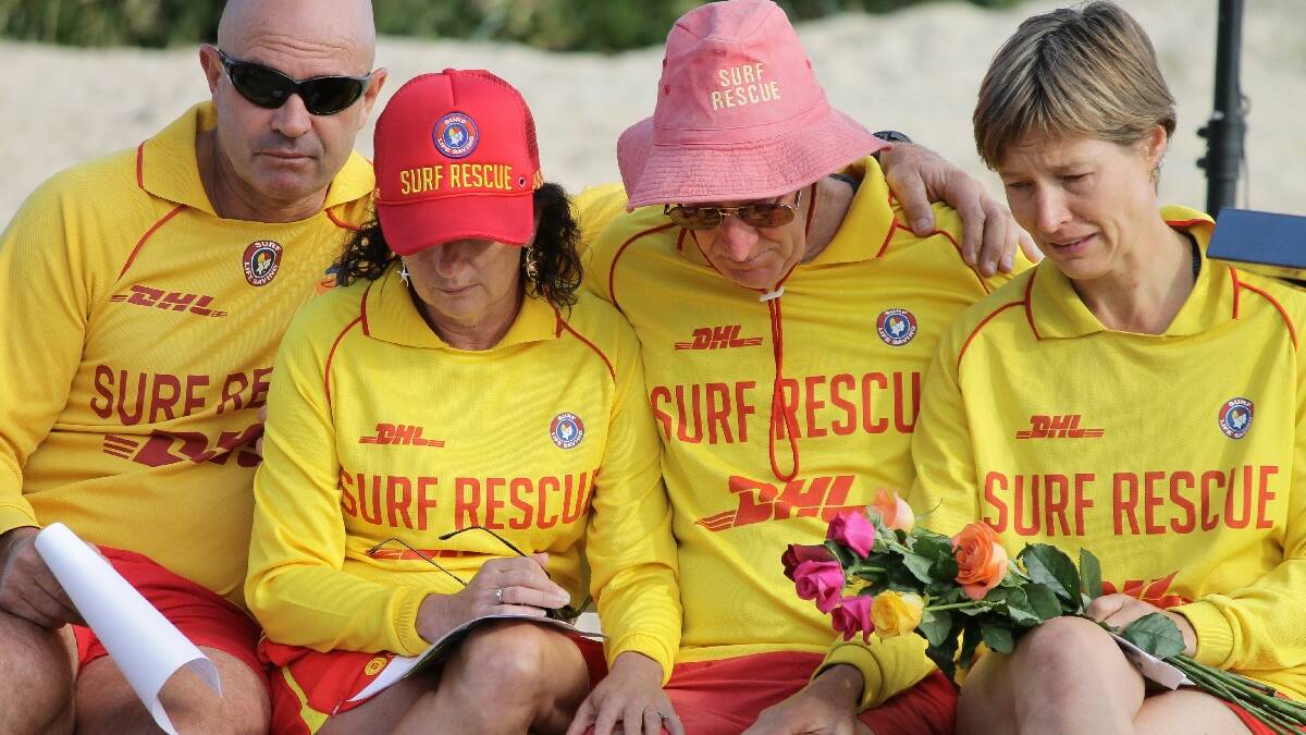 TATHRA: Rob Armstrong (second from right) is comforted by Tathra Surf Life Saving Club members Tony and Judy Rettke and Jennifer O’Leary at the Tathra Beach memorial service for his wife Christine. 