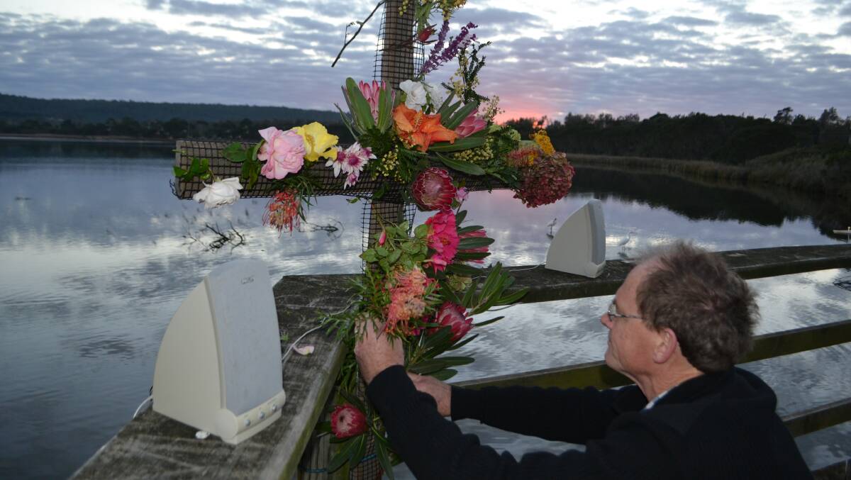 EDEN:  Worshippers decorated an unadorned cross to celebrate Christ’s resurrection, as the sun began to rise over Lake Curalo on Easter Sunday. 
