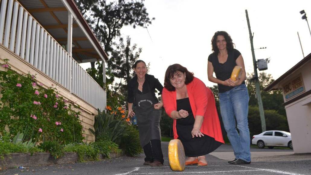 TILBA: Tilba Festival organising committee member Christine Montague demonstrates the cheese rolling flanked by Zoe Cooper and Erica Dibden from the ABC Cheese Factory. The festival is on all day this Easter Saturday on the main street of Central Tilba with lots of activities and an emphasis on local produce including River Cottage Australia host Paul West opening proceedings! 