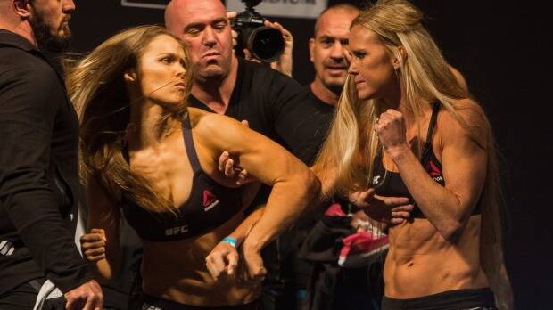 Ronda Rousey (l) confronts Holly Holm (r) during their weigh in at Etihad Stadium. Photo: Chris Hopkins
