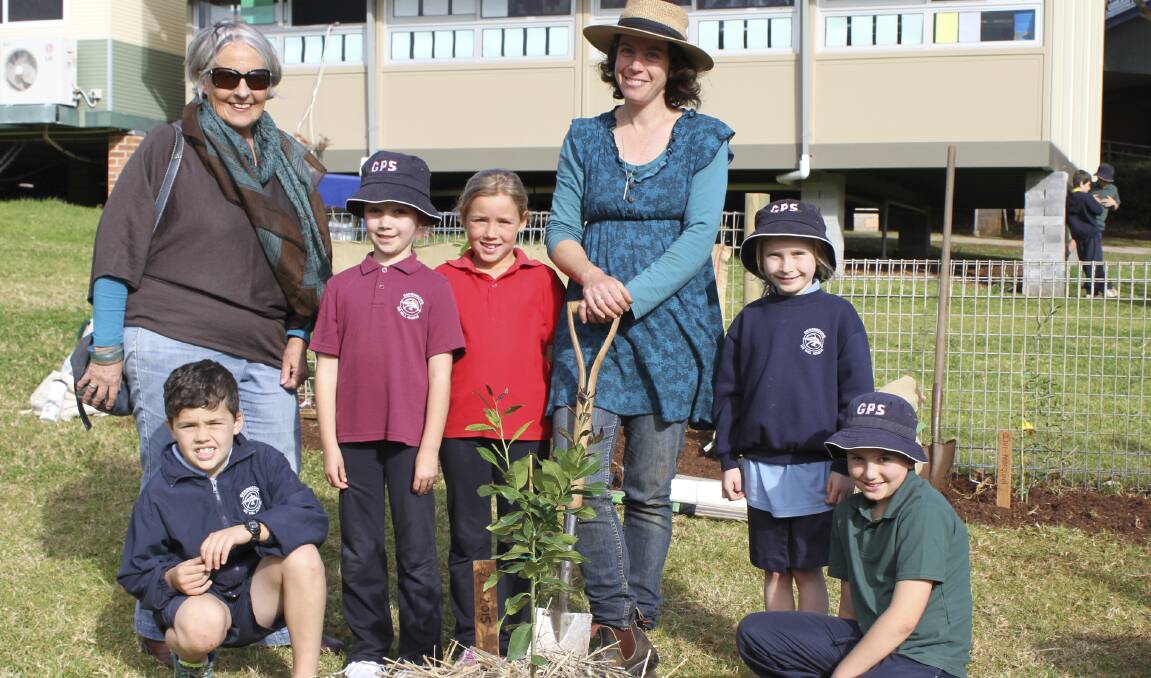 Sponsor Carolyn Evans from Slow Foods Saddleback and Gerringong Public School parent and orchard organiser of Gerringong Gardening Grubs Penny Sadubin with Gerringong Public School year 2 students after planting a Eureka Lemon Tree as part of the school’s new orchard. Picture: DAVID HALL