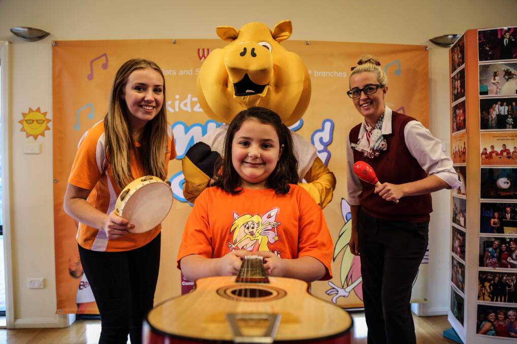 Lydia Beaven from Kidzwish, Caitlin Ivanovski with Pig and Shellharbour Bendio Bank Branch Manager Casey Harlow. Picture: GEORGIA MATTS