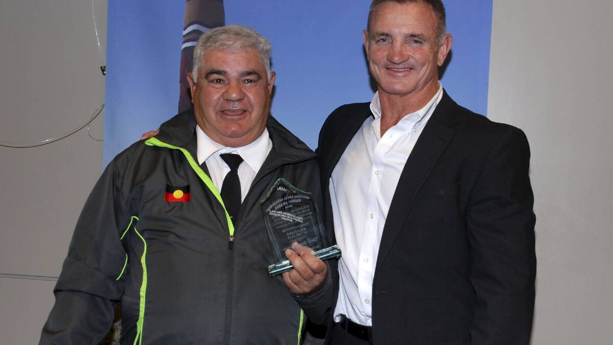 Uncle Gerald Brown receives his award from Shellharbour City councillor David Boyle. 