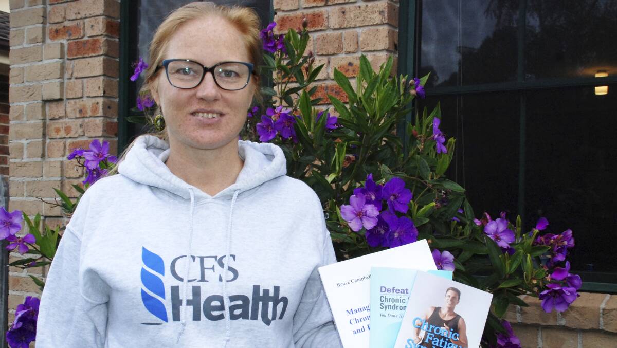 Chronic fatigue syndrome sufferer Ainslie Eccleston with some of the publications that helped her cope.  DAVID HALL