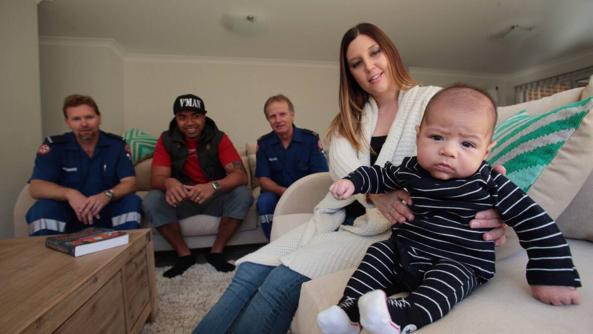 Paramedics Robert Shaw and Tony White with new parents Tovio Emani (rear, centre) and Kristy Emani and 10 week old Beniah Emani. picture: ADAM McLEAN 