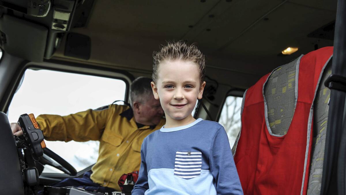 Hunter Davies having a great time in the Albion Park RFS fire truck. Picture: GEORGIA MATTS