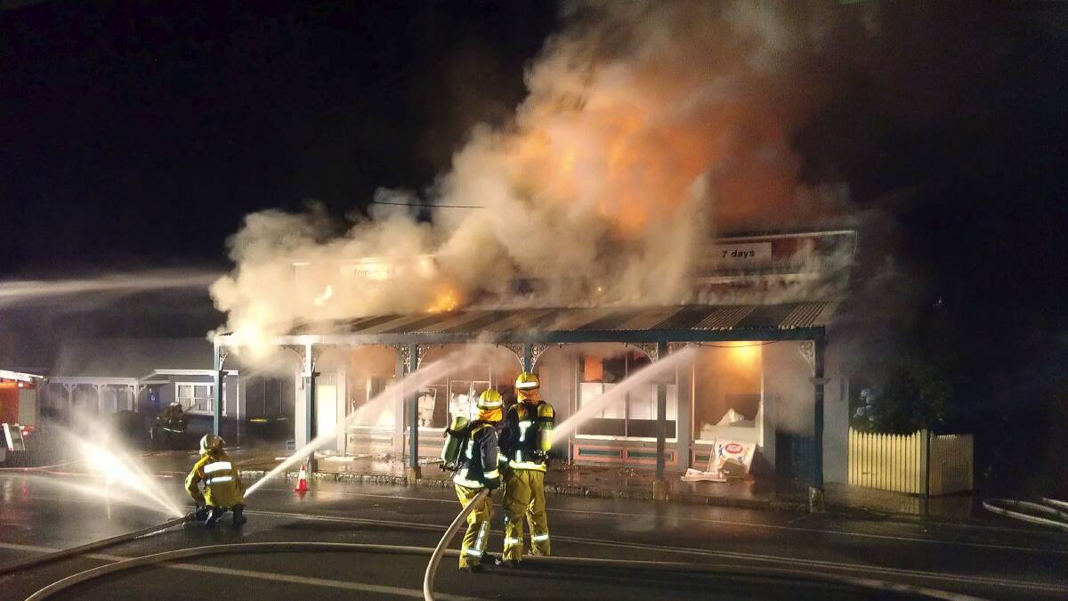 Firefighters fight a losing battle against the fire at the Jamberoo IGA. 