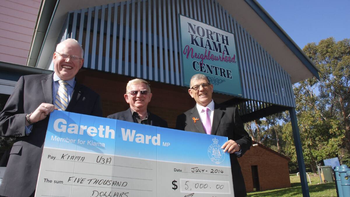 KIAMA MP Gareth Ward (left) and NSW Minister for Ageing John Ajaka (right) present Kiama U3A president Peter Clarke with $5000 worth of funding to help the organisation cover venue hire costs. Picture: PHIL McCARROLL 