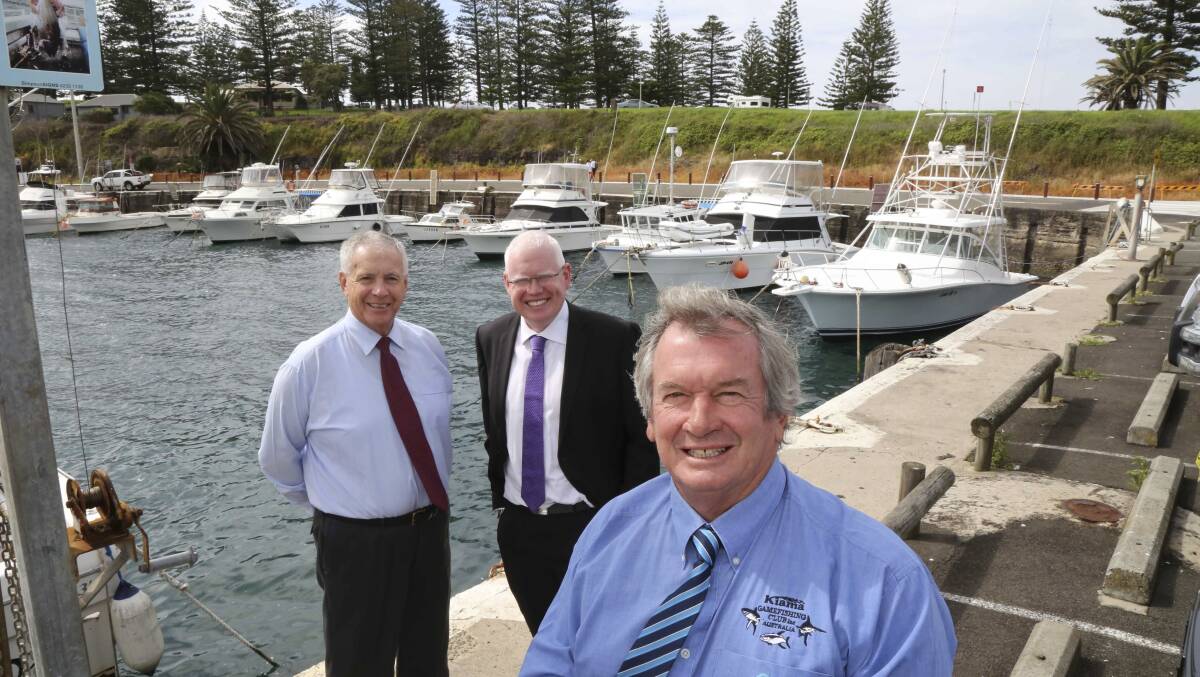 Kiama councillor Mark Way (front), mayor Brian Petschler (left-rear) and MP Gareth Ward at Kiama Harbour last week. More than $40,000 will be spent there on upgrades.    