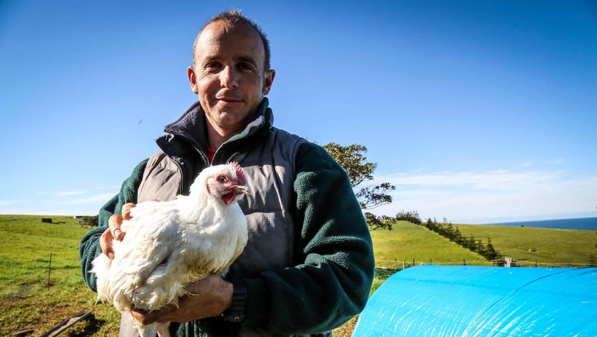 Buena Vista Farm's Adam Walmsley with one of their pasture-fed chickens. Picture: GEORGIA MATTS