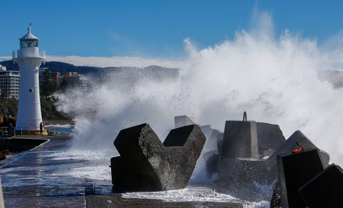 A large concrete block, which forms part of the Wollongong Harbour breakwall lies on its back after being pushed over by the weekend's king tide. 