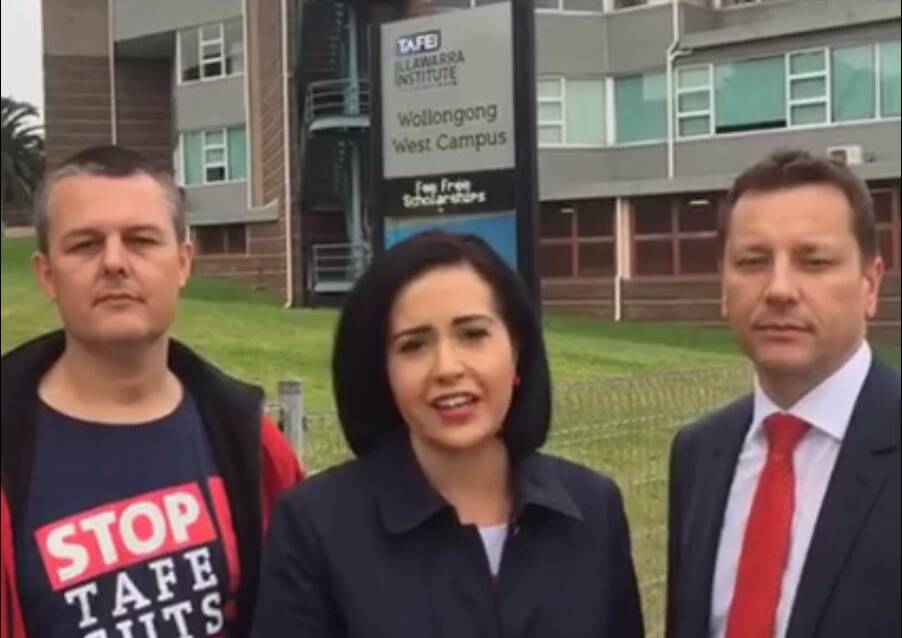 A screengrab of Prue Car's Facebook Live video, with union rep Adam Curlis (left) and Labor's Paul Scully, shows "Fee Free Scholarships" advertised on the sign.