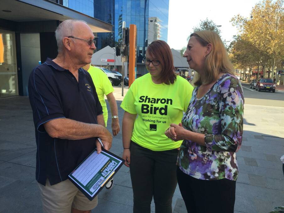 Member for Cunningham Sharon Bird (right) chats with a passer-by in Wollongong's Crown Street Mall on Friday morning. The Labor MP's collecting signatures on a "Save Medicare" petition. Picture: Andrew Pearson 