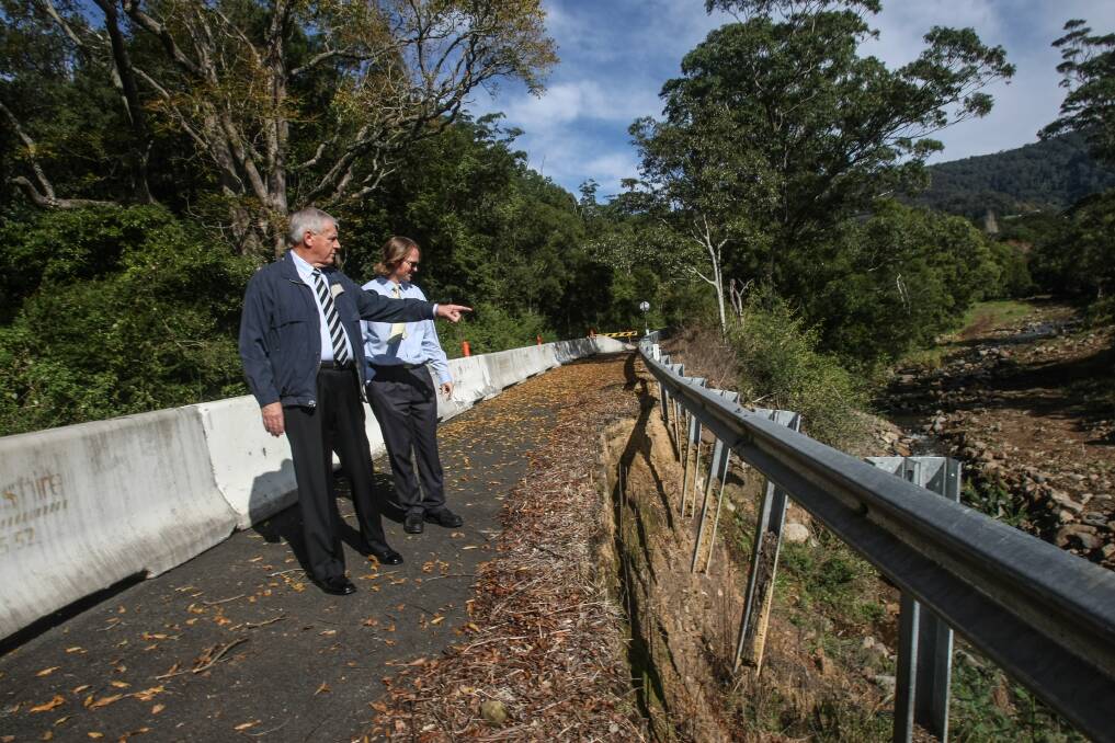Kiama Mayor Brian Petschler and council's design and development manager Darren Brady inspect one of the sites being repaired on Jamberoo Mountain Road. Picture: DYLAN ROBINSON