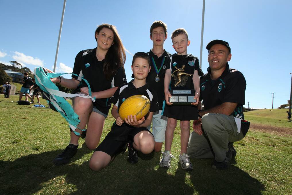 Kiama Independent. Sport. Kiama Power Junior AFL Youth girls under-15s player Claire McCombe, under-9s player Adam Moloney, under-16s player James Lees and Auskick's Max Shelley with Club President Simon Williams. The club's junior's took out the 2012 Club Championship. 15/09/2012 Photo Dylan Robinson/DCZ