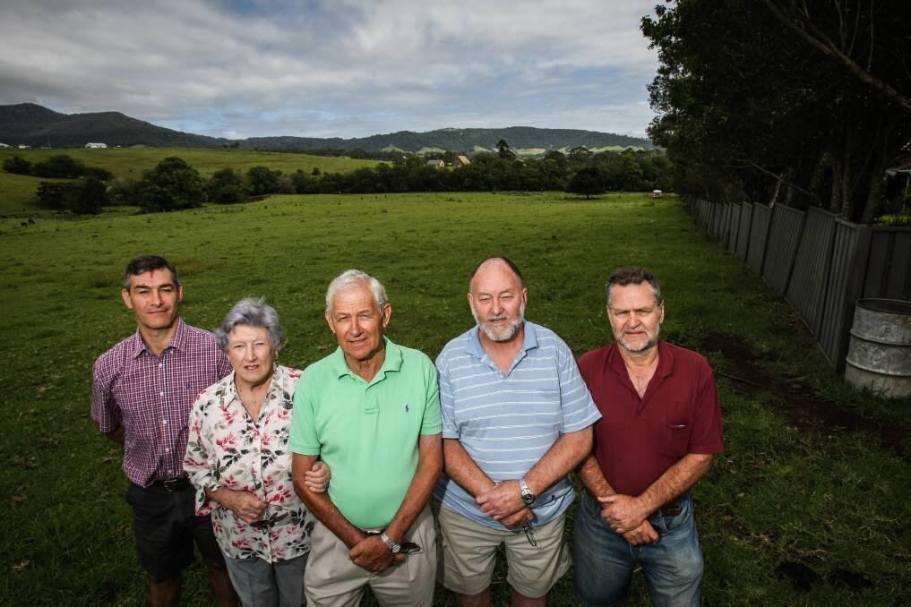 Jamberoo residents (from left) Peter Judd, Gwen Tate, Reg Curnow, John Warner and John Friedmann are concerned about a Wyalla Road development which they say could bring problems, including flooding, and which lacks basic services.
