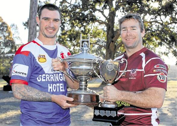 All smiles for now - Gerringong Lions captain Ryan Staples and his Albion Park-Oak Flats opposite Dean Gray with the Artie Smith Cup and VB Cup that will be up for grabs in next Sunday's grand final. Picture: DAVID HALL