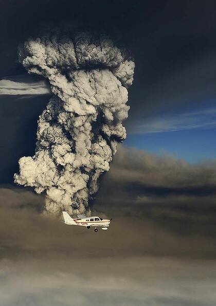 Up close ... a plane flies past a plume of ash from the eruption of the Grimsvotn volcano.