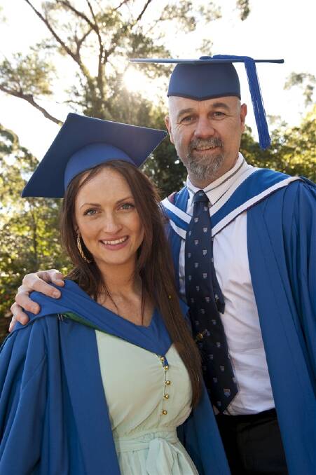 Father and daughter Brad Parkinson and Erin Watt enjoy some well-earned downtime after they graduated together with commerce degrees  in the same ceremony on Friday at the University of Wollongong. DYLAN ROBINSON 