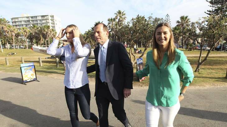 Tony Abbott arrives to vote at Freshwater Surf Club with his daughters. Photo: Nick Moir