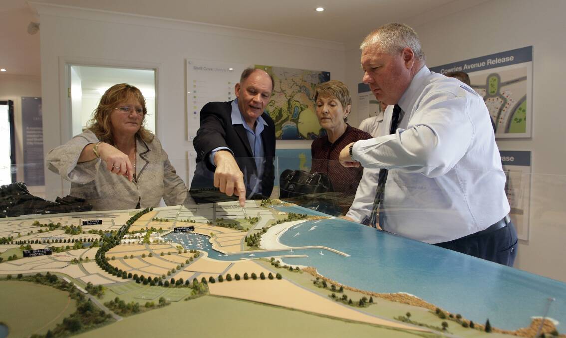 Shellharbour Mayor Marianne Saliba, Shell Cove commercial manager Kevin James, councillor Helen Stewart and deputy mayor Paul Rankin inspect the shape of the planned marina. Picture: ANDY ZAKELI