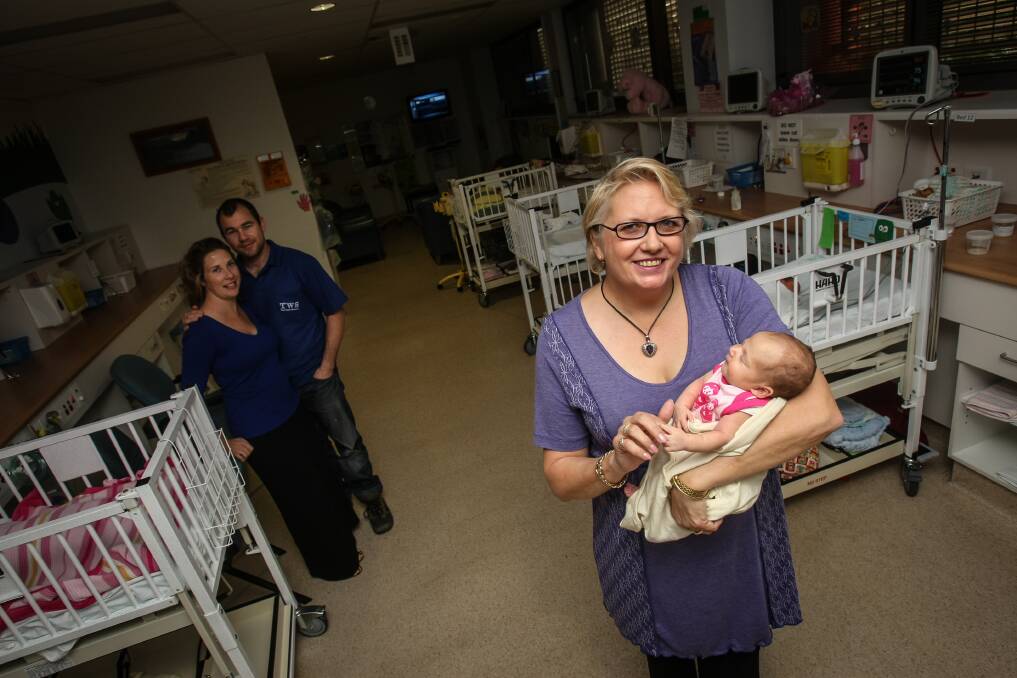 Midwife of the year Yvonne Medina with one of her recent arrivals, two-week-old Ava Thormann and her parents Jason and Sarah. Mrs Medina says all of the midwives at Wollongong Hospital should share in her recent award. Picture: DYLAN ROBINSON