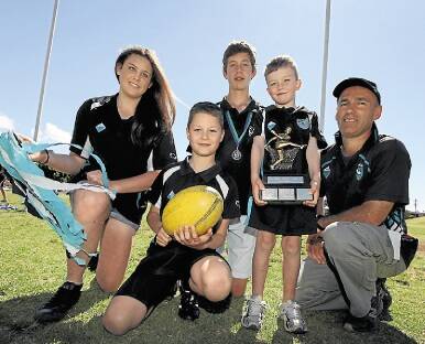 Kiama Power Junior AFL Youth girls under-15s player Claire McCombe, under-9s player Adam Moloney, under-16s player James Lees and Auskick's Max Shelley with Club President Simon Williams. The club's junior's took out the 2012 Club Championship. Photo Dylan Robinson