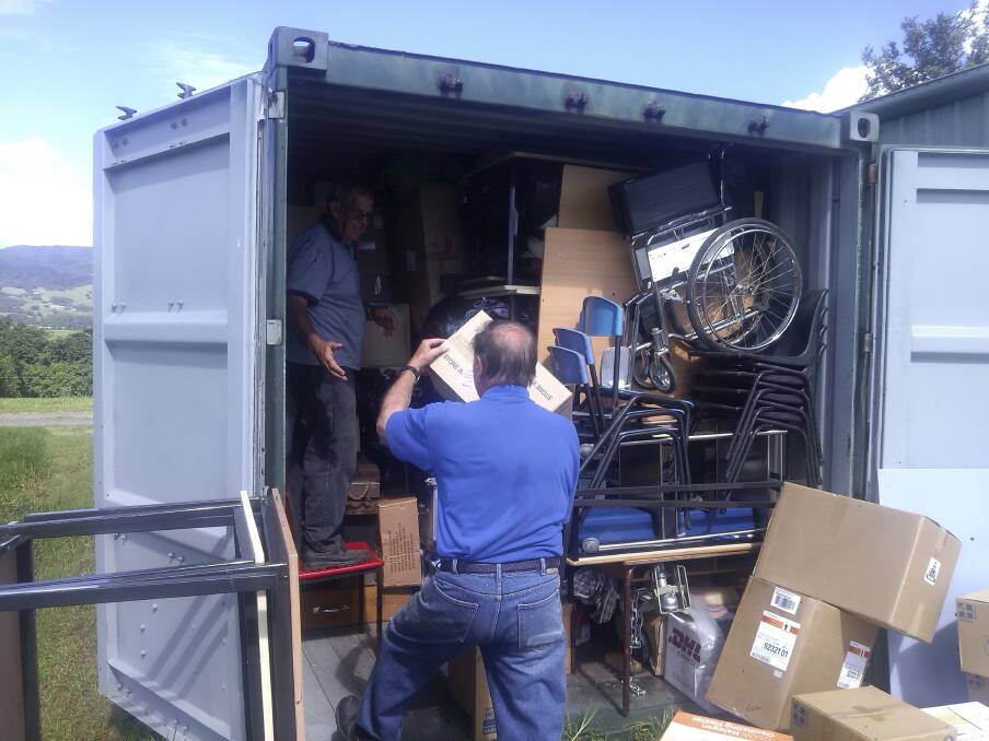 Kiama Rotarians Noel Edgell and Alan Schofield pictured packing the final items into the shipping container when it was bound for Madang.