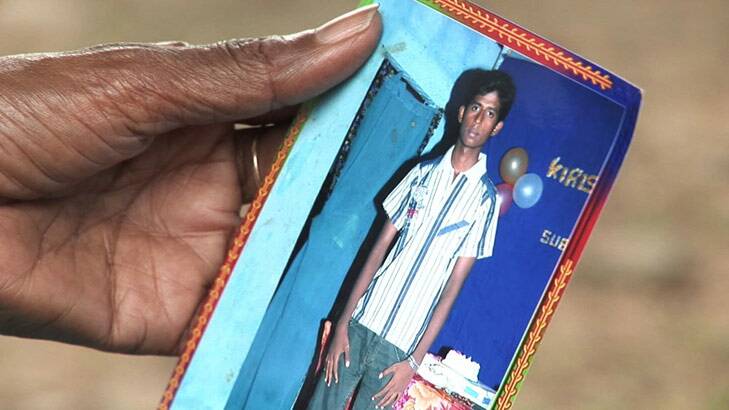 Rani holds a photo of Tushanthan, who paid to travel by boat to Australia.