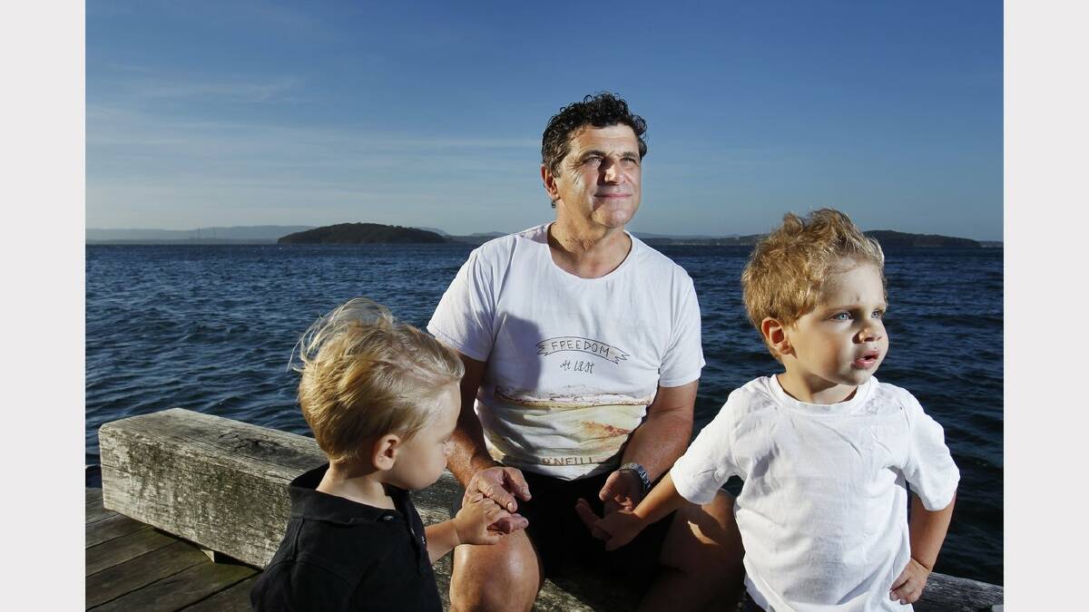  Lorenzo Corradi of Murrays Beach is concerned about the Great White shark which has been sighted several times around Pulbah Island (in background, L) and says people need to be made aware of it. Pictured with his sons Rocco, left, 1, and Koby, right, aged  3 at Murrays Beach Jetty. Picture Max Mason Hubers. 