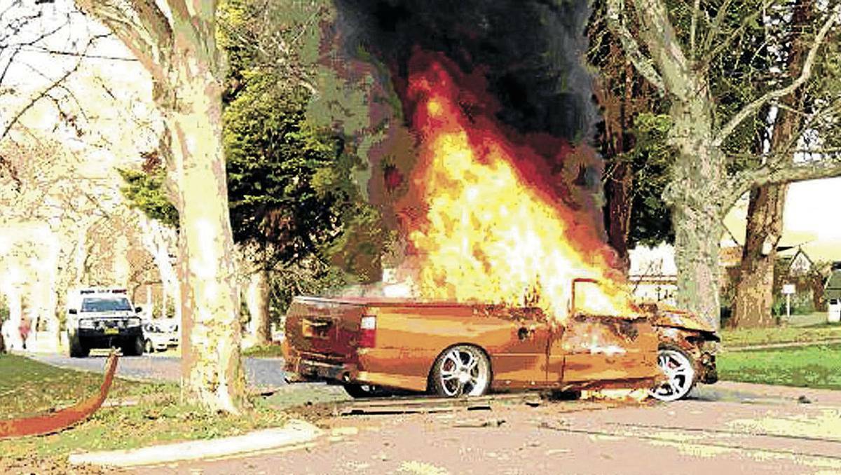 This Holden ute burst into flames after crashing into a tree in Narrandera, NSW on Thursday. Police allege that the men had done a burnout along Larmer Street through a school zone before crashing into the tree. Picture: Supplied