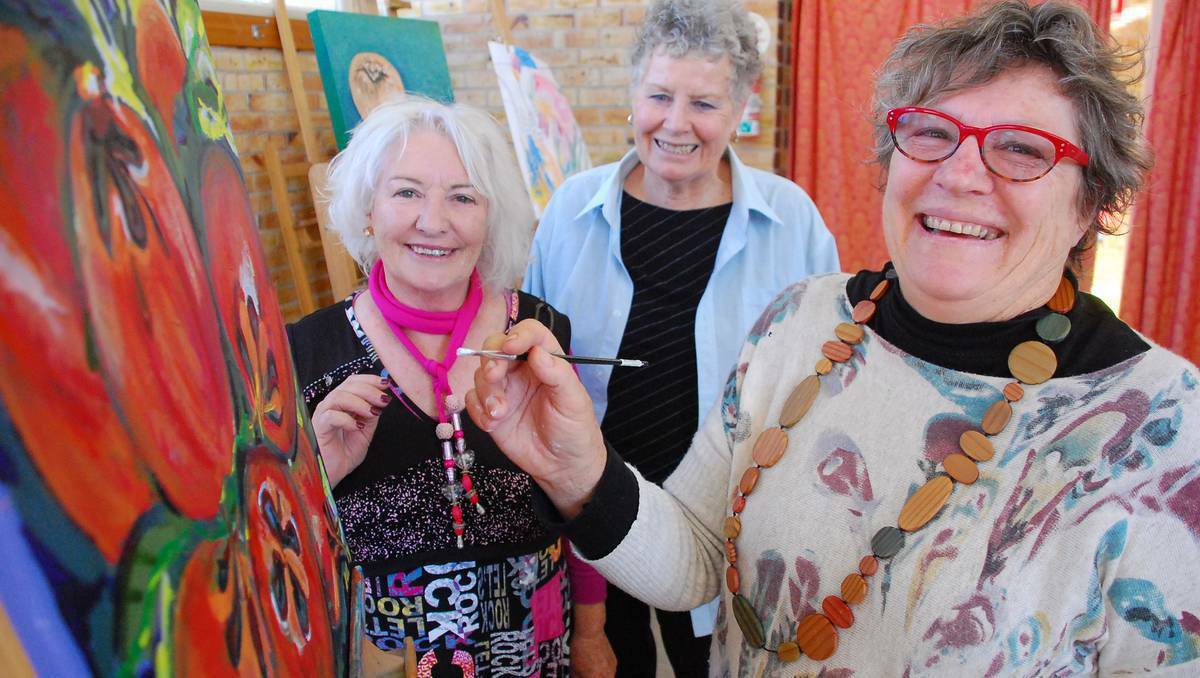Murray Bridge Regional Art Society members Jeanette Glasson, Mary Rawlings and Sue Foster prepare for the SALA Festival, which began on Friday.