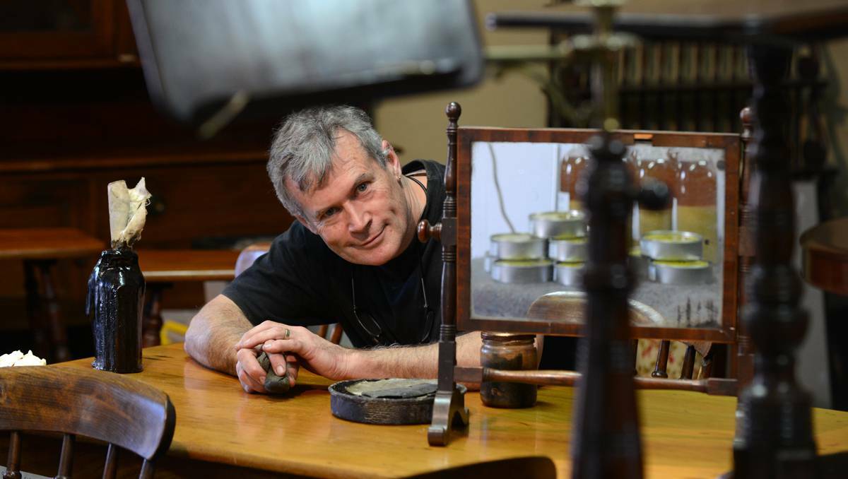  Brenton Kinnear at the Tamworth Antique and Collectables Fair with some of the tools of his antique conservation trade – wet and dry sandpaper, shellac and French polish. Picture: Barry Smith