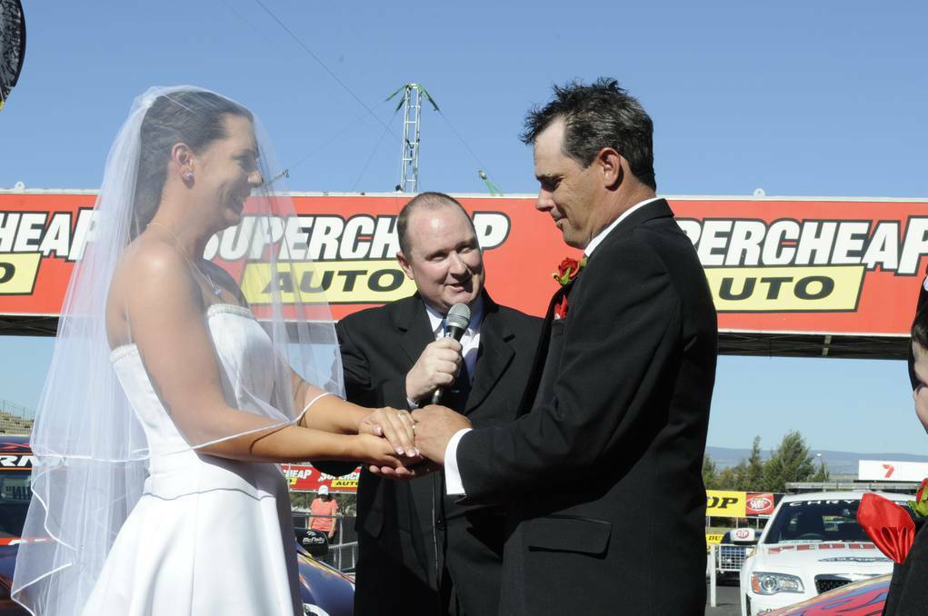 Bathurst 1000 race officials Shane and India tie the knot in Pit Lane at Mt. Panorama. PHOTO: Chris Seabrook.