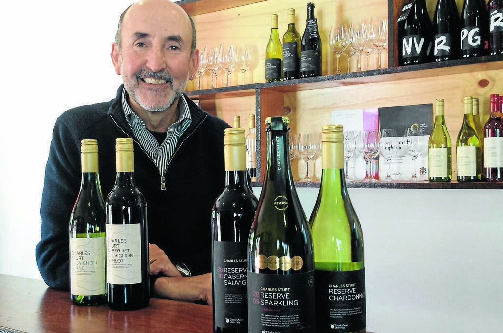 Charles Sturt Wines marketing manager Justin Byrne with the new labels that feature a map of the travels of Captain Charles Sturt.