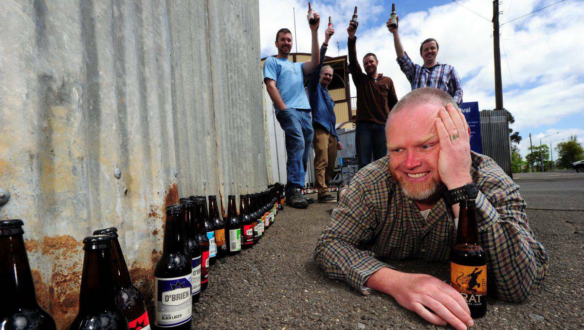 Craft beer enthusiast Al Whelan and fellow connoisseurs Drew Graham, Hunter Sedgwick, Dan Mulquiney and Zac Powell celebrate 99 bottles of beer on the base of the wall ahead of next year’s Ballarat Beer Festival. PHOTO: Ballarat Courier.