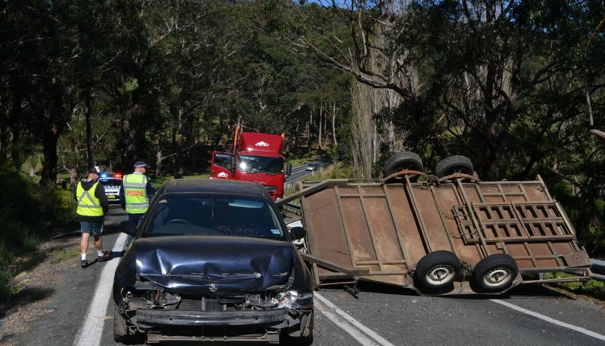 NAROOMA: A single-vehicle accident near Tilba Tilba south of Narooma closed the Princes Highway last Friday morning. A Jeep that was being towed behind the Commodore is obscured behind the trailer. 