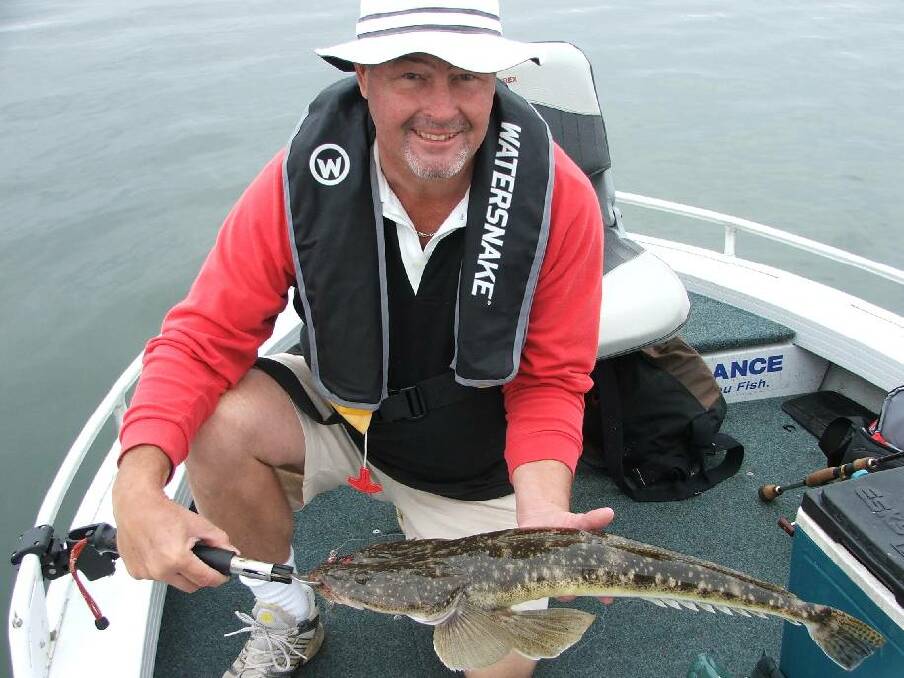 CHOICE FLATHEAD: Brett Murray from Sydney fished a local lake south of Narooma with Calm Water Charters on Monday getting heaps of flathead, including this 76cm model on a Zman plastic. (30/10/2013) 