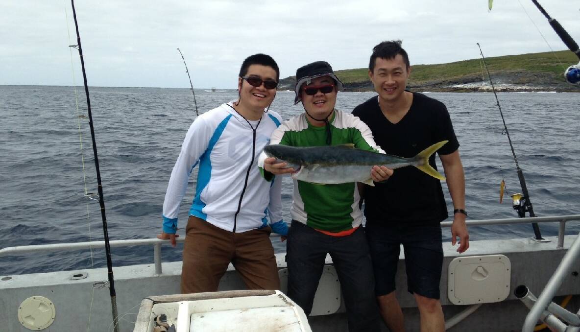 SHERIFF KING: Ralph Yam with his kingfish and friends on board The Sheriff at Montague Island on Sunday. 18/12/2013