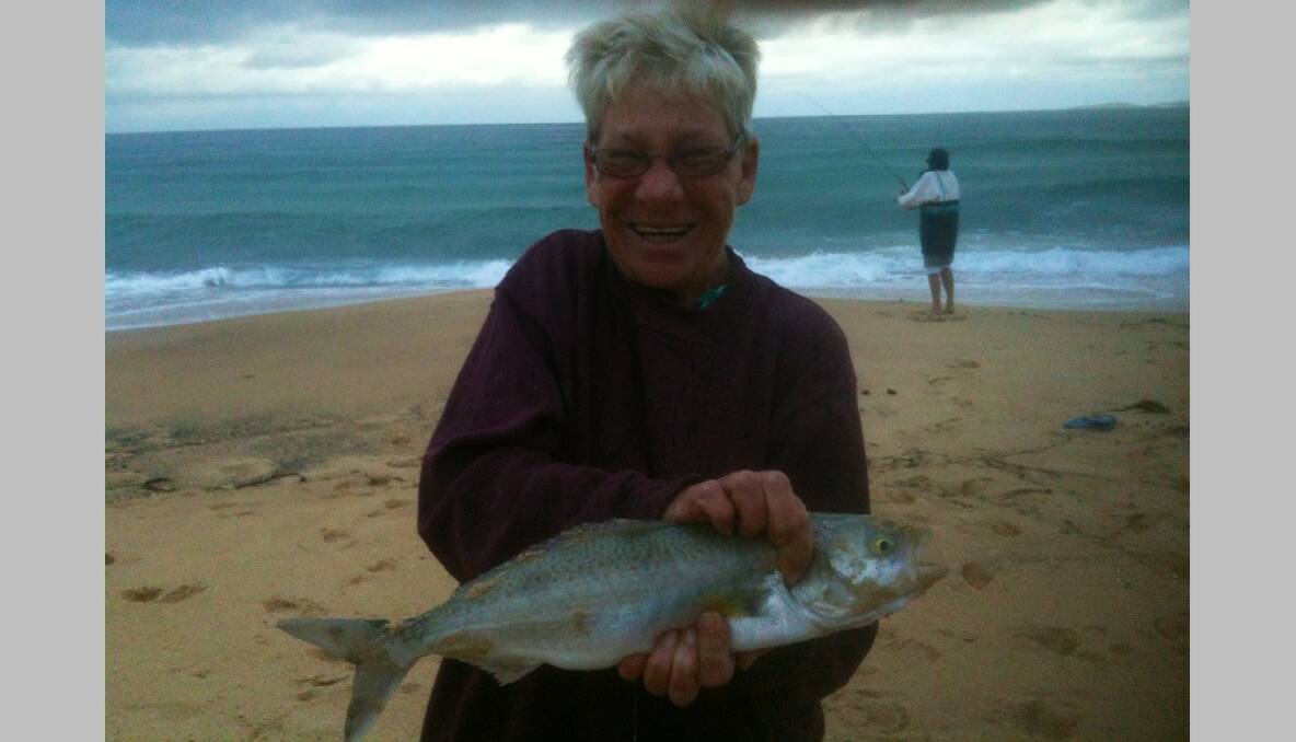 CLUB SALMON: Jill Johnston of Narooma Sport and Gamefishing Club with a nice salmon caught off Carter's Beach on a pilchard tail while fishing in the club's December competition on Saturday morning. 18/12/2013 