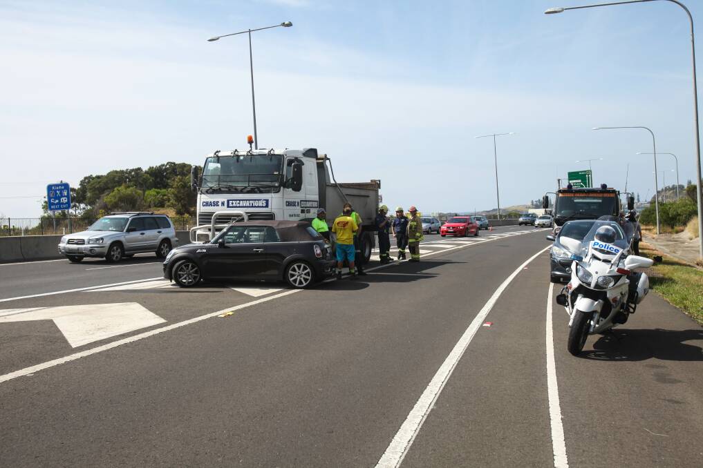Traffic travelling northbound on the Princes Highway was reduced to one lane after a truck and a convertible Mini Cooper collided near the Bombo interchange on Thursday. Picture: DANIELLE CETINSKI