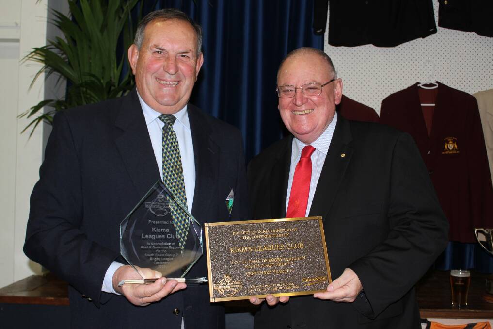 Kiama Leagues Club chairman Bruce Dun accepts the club's Centenary plaque from Clubs NSW chairman Peter Newell on Friday night. Picture: DAVID HALL