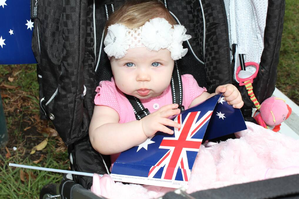 Young Isabella Ward got into the swing of things, holding an Australian flag.