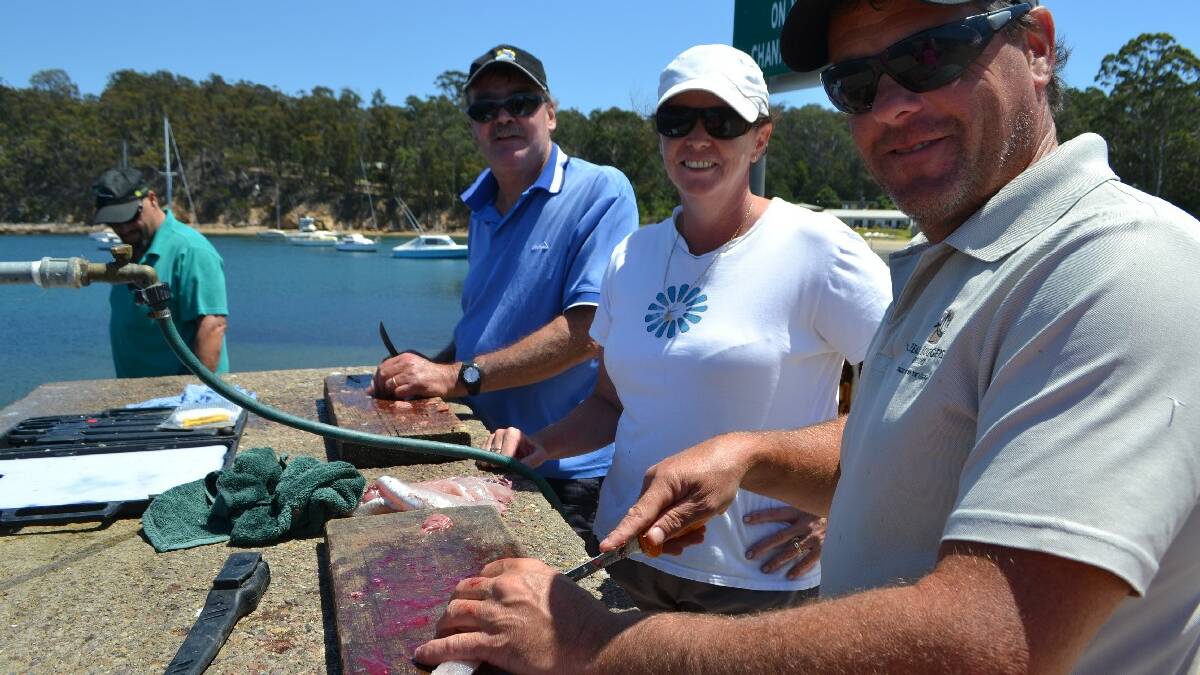 EDEN: From left; Dave and Kerry Hughes from Lakes Entrance and Michael Young from Orbost are enjoying fishing in Eden over the summer.  Their catch of flathead, combined with a “few coldies”, was the plan for a magnificent al fresco dinner on Tuesday.