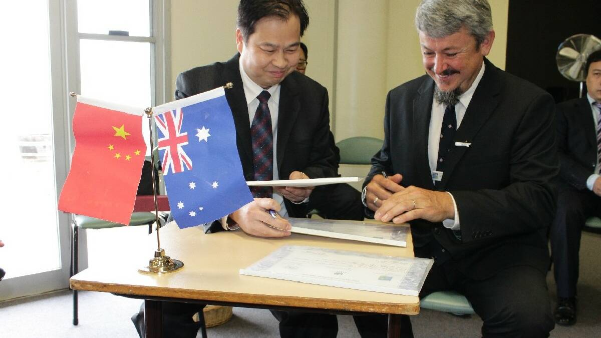 BEGA: During a Chinese delegation to the Bega Valley, Vice Secretary-General of Wenzhou Municipal Government Chen YoungGuang and Sapphire Coast Anglican College head of school Andrew Duchesne smile as they sign a Memorandum of Understanding for Friendship.