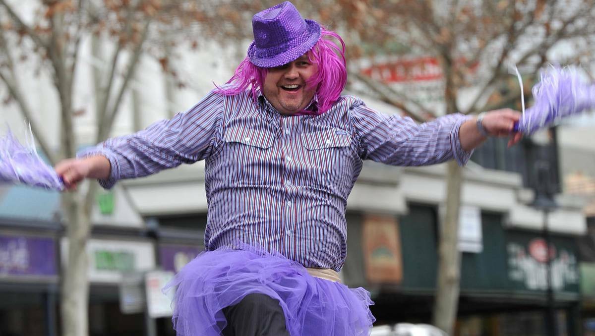  Manager of Sureway Wagga Paul Snudden does a jig at the traffic lights intersection of Tompson and Baylis Streets. Picture: Michael Frogley