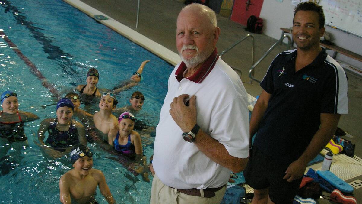 ULLADULLA:  Internationally renowned swim coach Doug Frost (front) shares some tips with squad coach Dene Roulstone and young swimmers at the Ulladulla Leisure   Centre where he has just started work.